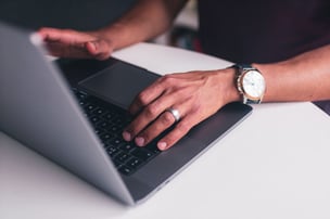 Hands on a laptop keyboard